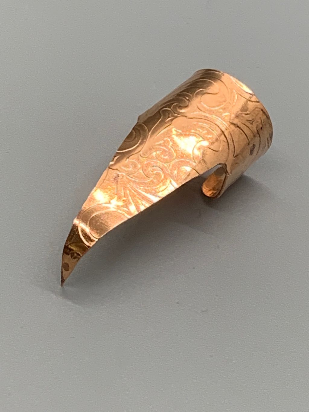 Copper claw with embossed art nouveau design, no patina, polished.