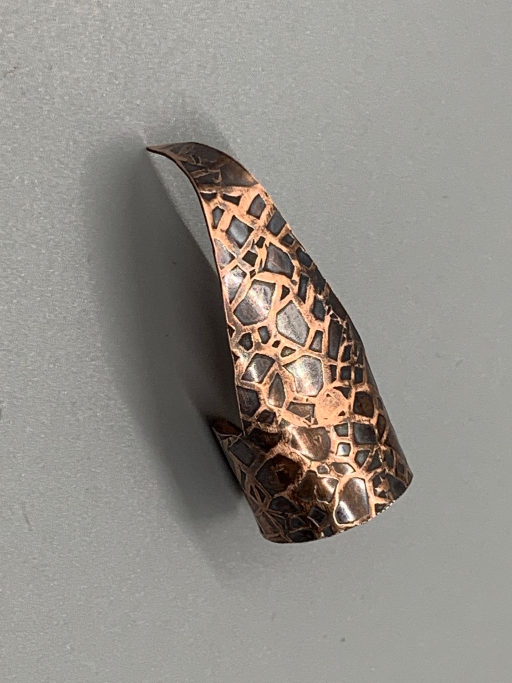 Copper claw with crackle texture emboss with patina.