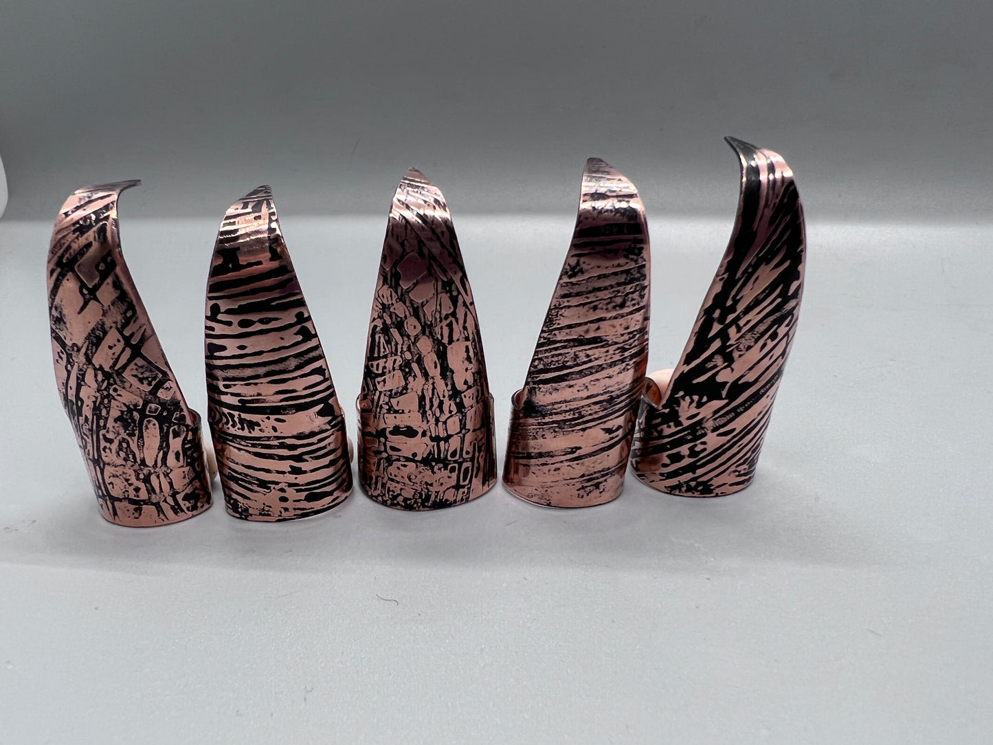 Copper claws embossed with woodgrain and patina'd, set of five.