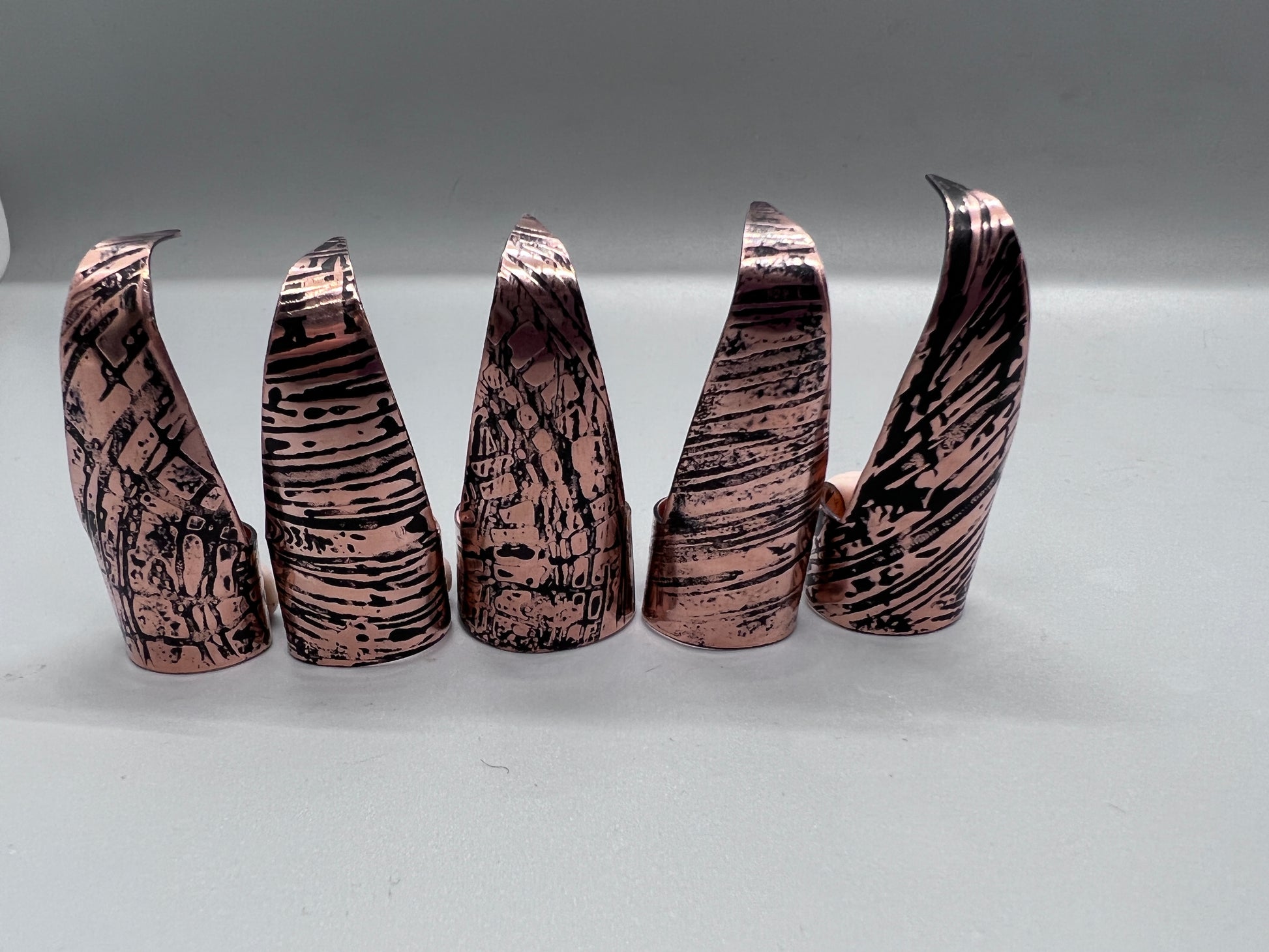 Copper claws embossed with woodgrain and patina'd, set of five.