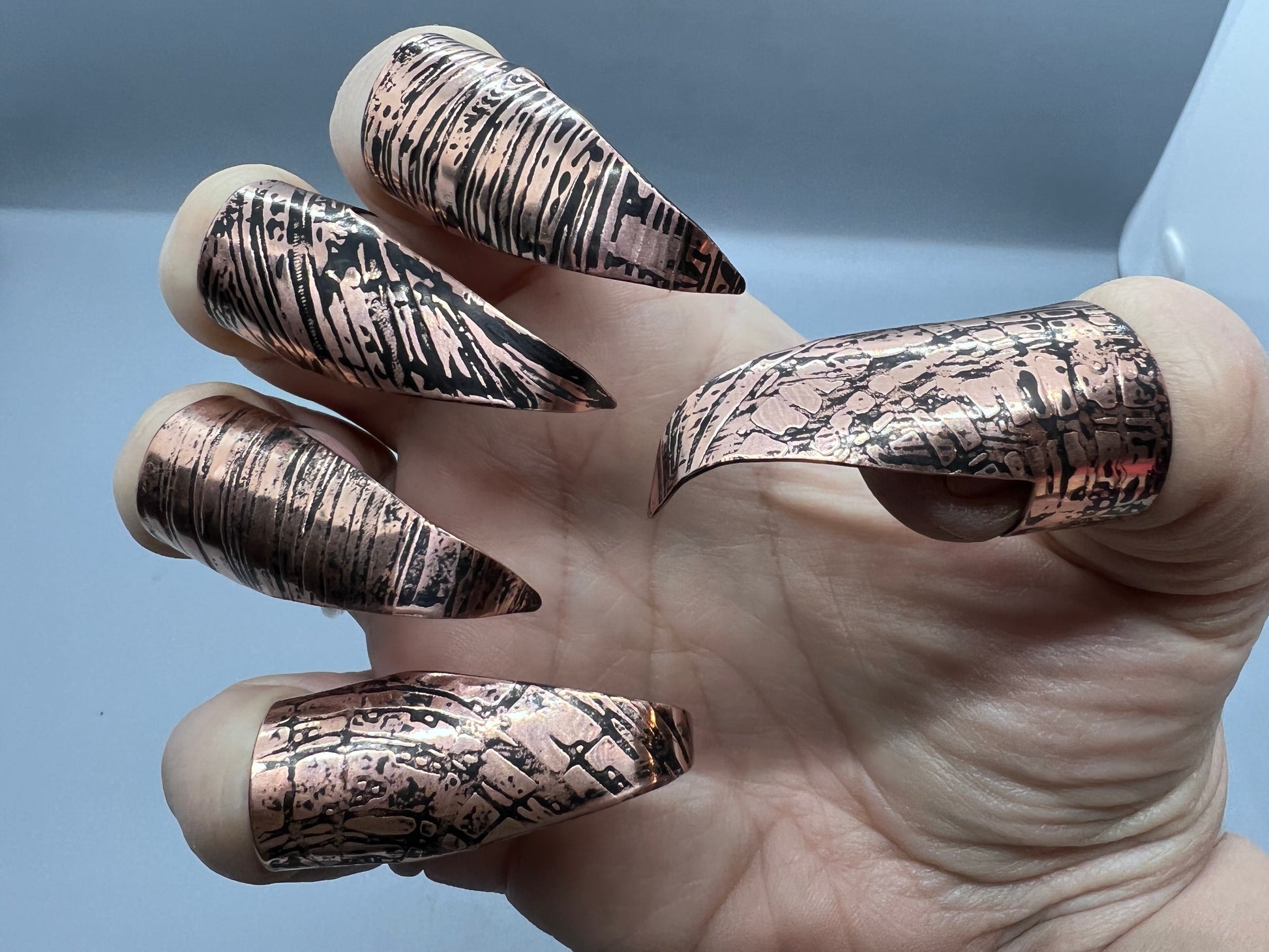 Copper claws embossed with woodgrain and patina'd, set of five.