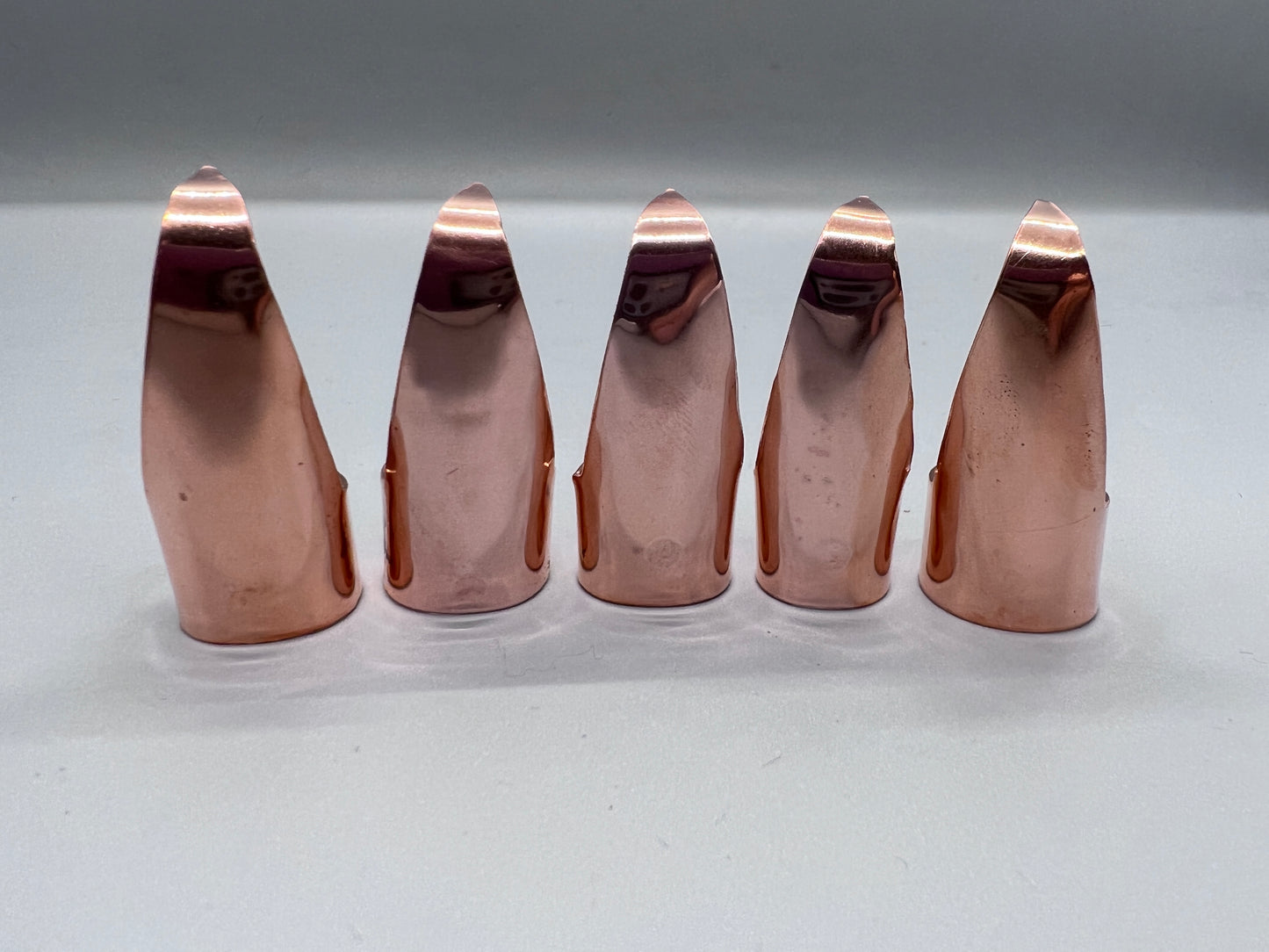 Plain (no texture) shiny copper claws, set of five.