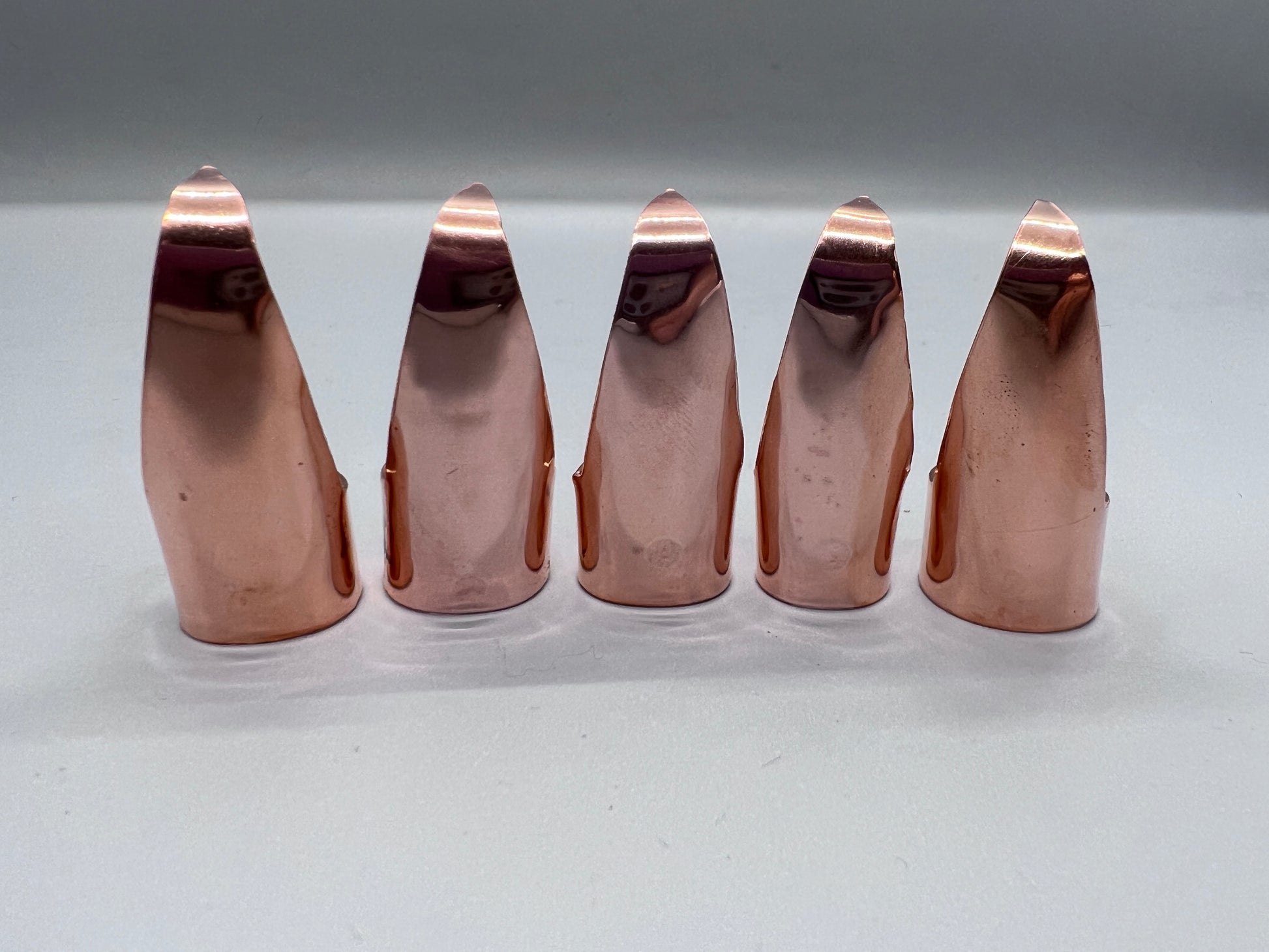 Plain (no texture) shiny copper claws, set of five.