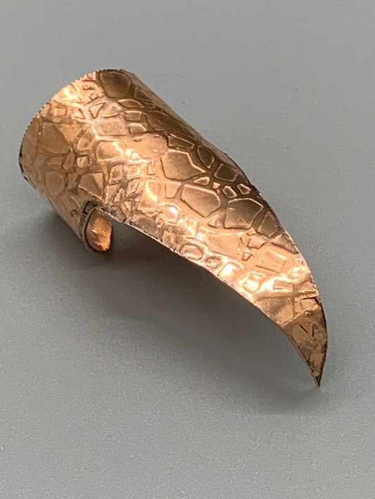 Shiny copper claw with a crackle texture emboss.