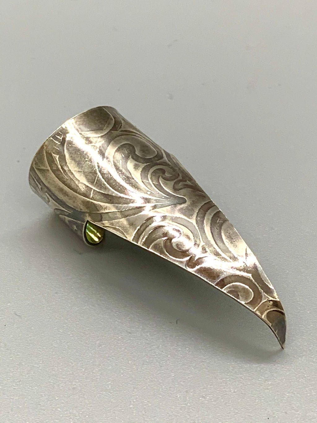 Sterling silver claw with embossed Art Nouveau pattern, antiqued