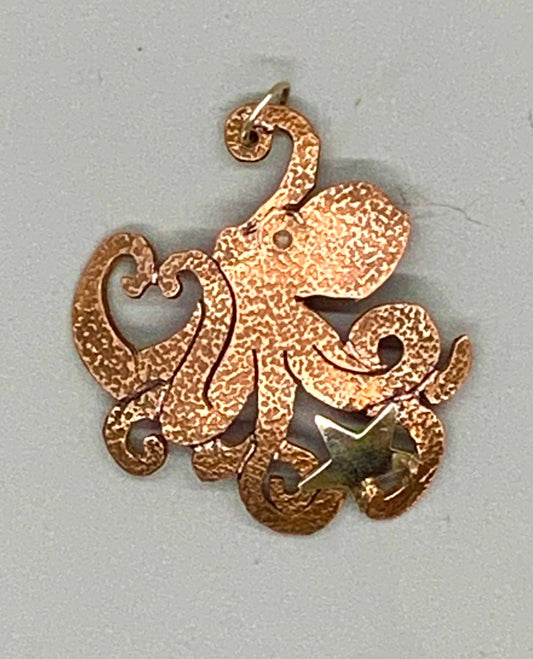 Copper saw-pierced octopus pendant holding a sterling star with an inset opal for an eye.