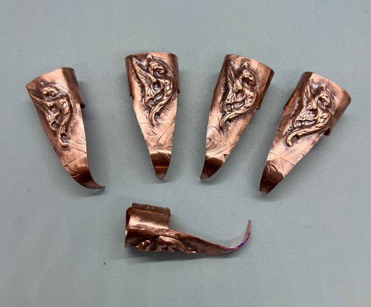 Copper claws embossed with a moon/scale background and a winged Victorian style dragon, set of five.