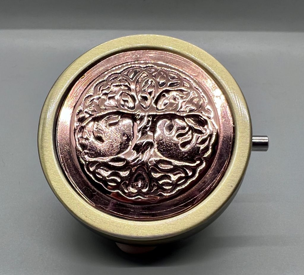 Pushbutton round pillbox with copper decoration of embossed Tree of Life.