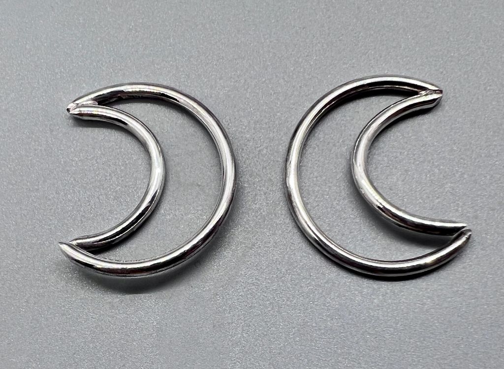 Sterling silver crescents with one end open for piercings.