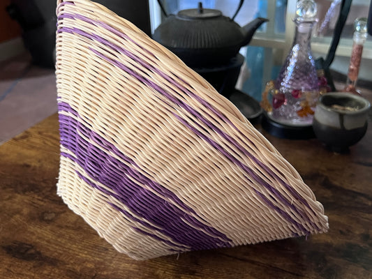 Handwoven reed basket in natural and purple.