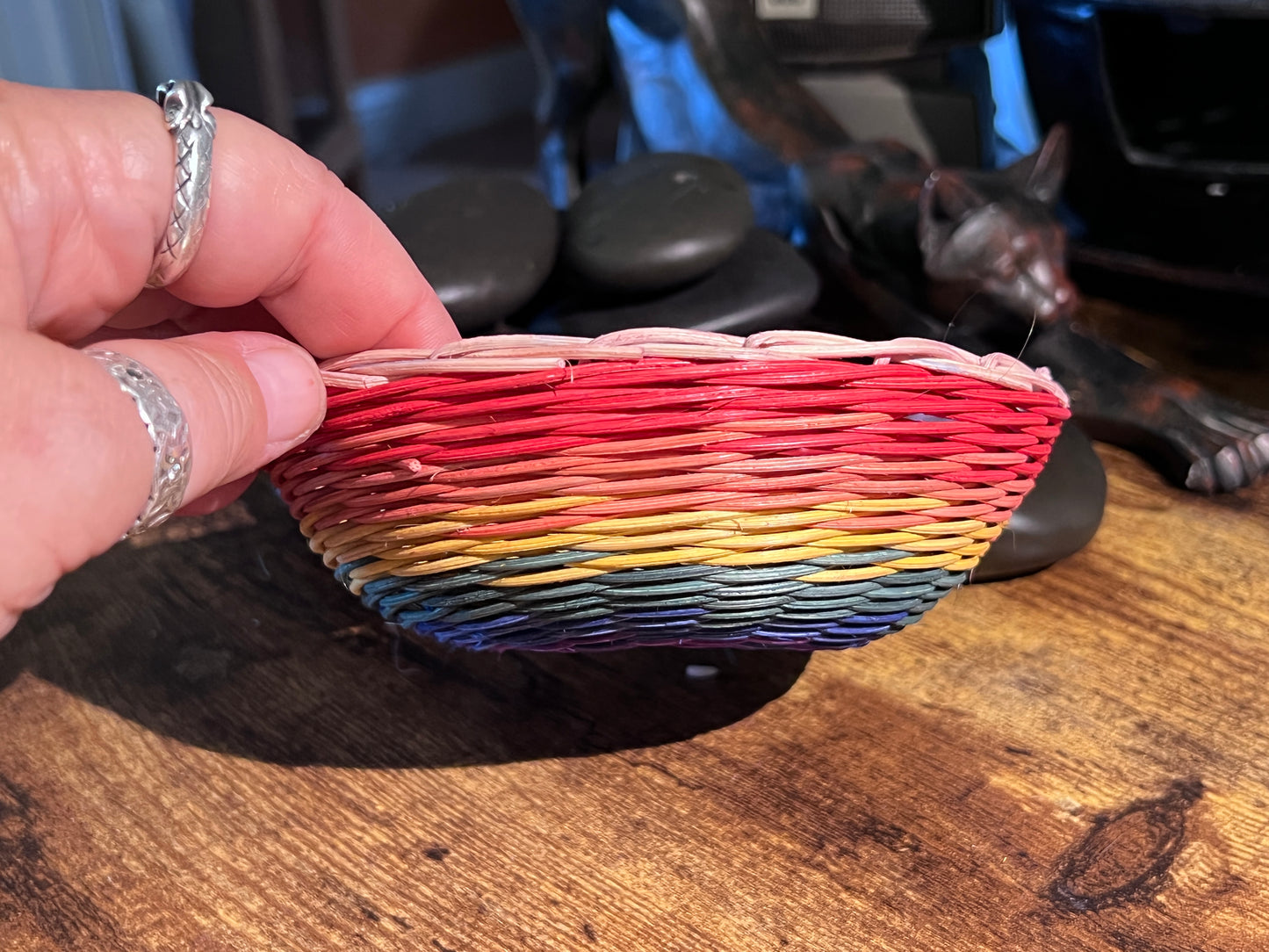 Small saucerbowl of handwoven reed in rainbow colors.