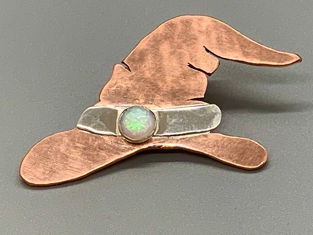 Copper saw cut witches' hat with a silver hatband and a bezel set opal.