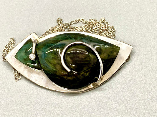 Pendant, silver, with an abstract cut and carved rainbow obsidian stone and a tubeset moissanite.