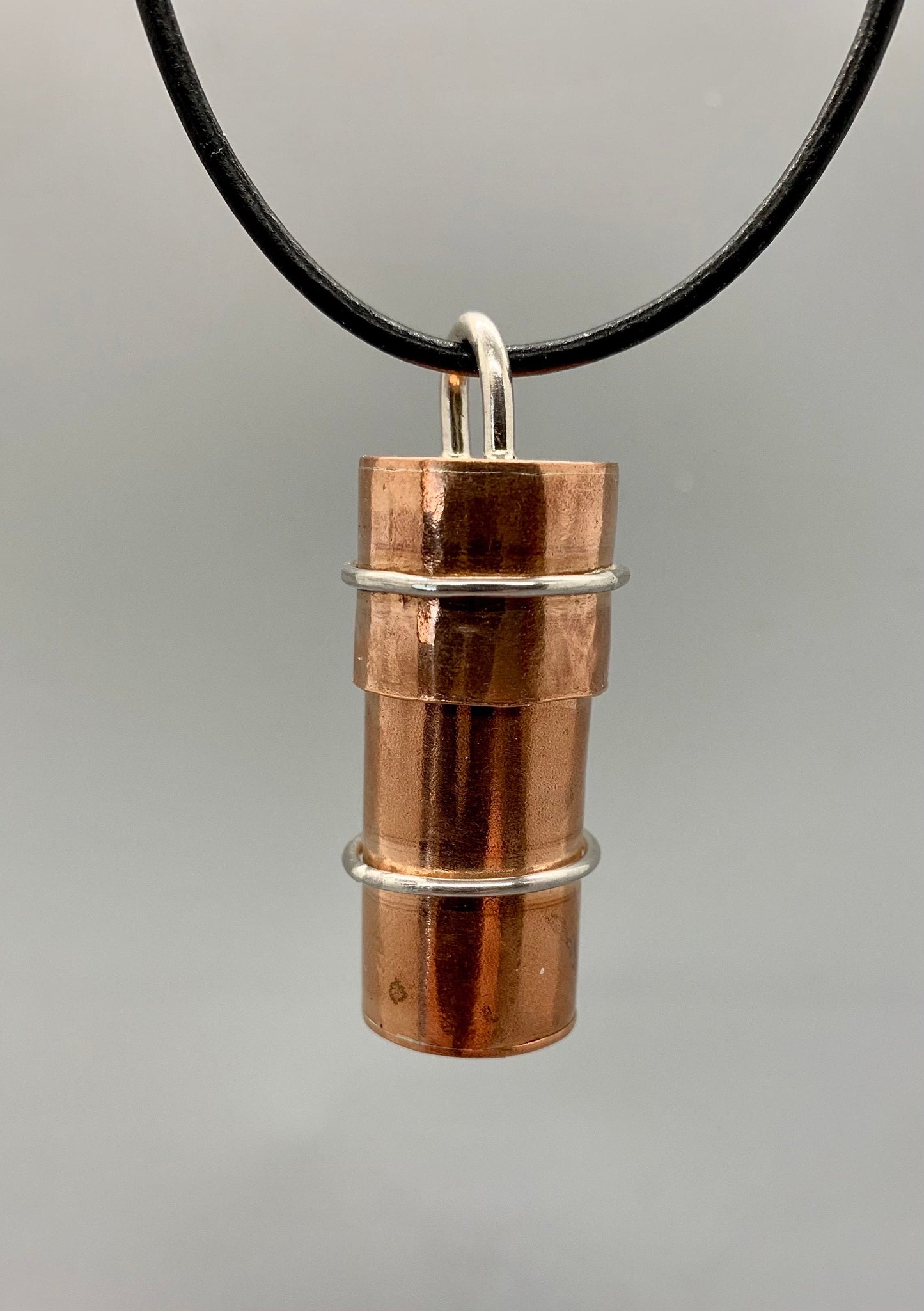 Plain shiny copper tube with silver ring highlights and a bayonet closure top.