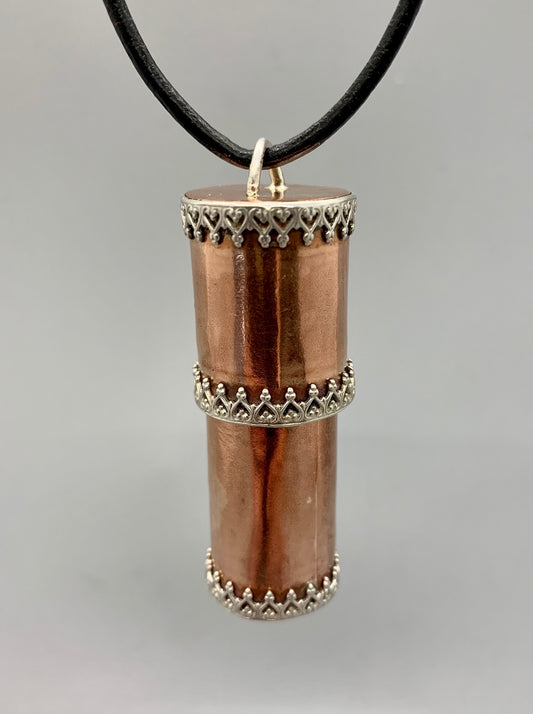 Smooth polished copper tube with bayonet closure lid, with fancy silver bezel wire.